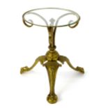 A late 19thC / early 20thC Art Nouveau style glass top table with an embossed brass base and three