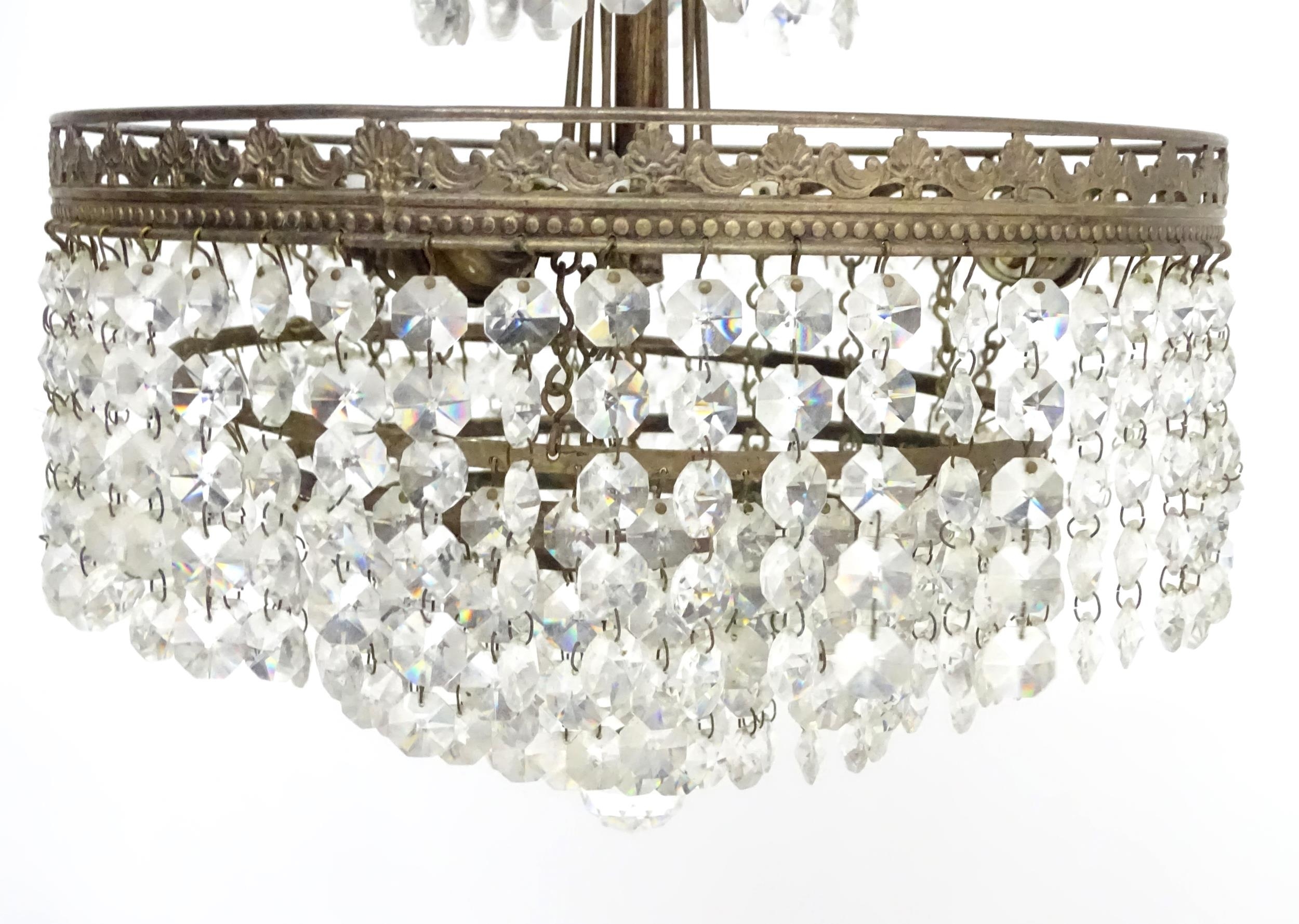An early 20thC crystal drop bag pendant ceiling light, the chain supporting brass mounts with a - Image 4 of 8