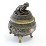 A Chinese cast brass three footed lidded censer, the body with twin handles and banded enamel