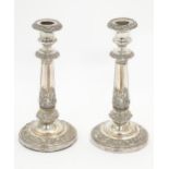 A pair of silver plate candlesticks with acanthus scroll decoration. Approx 9" high Please Note - we