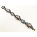 A silver Oriental bracelet with enamel and cabochon detail. Approx. 7" long Please Note - we do