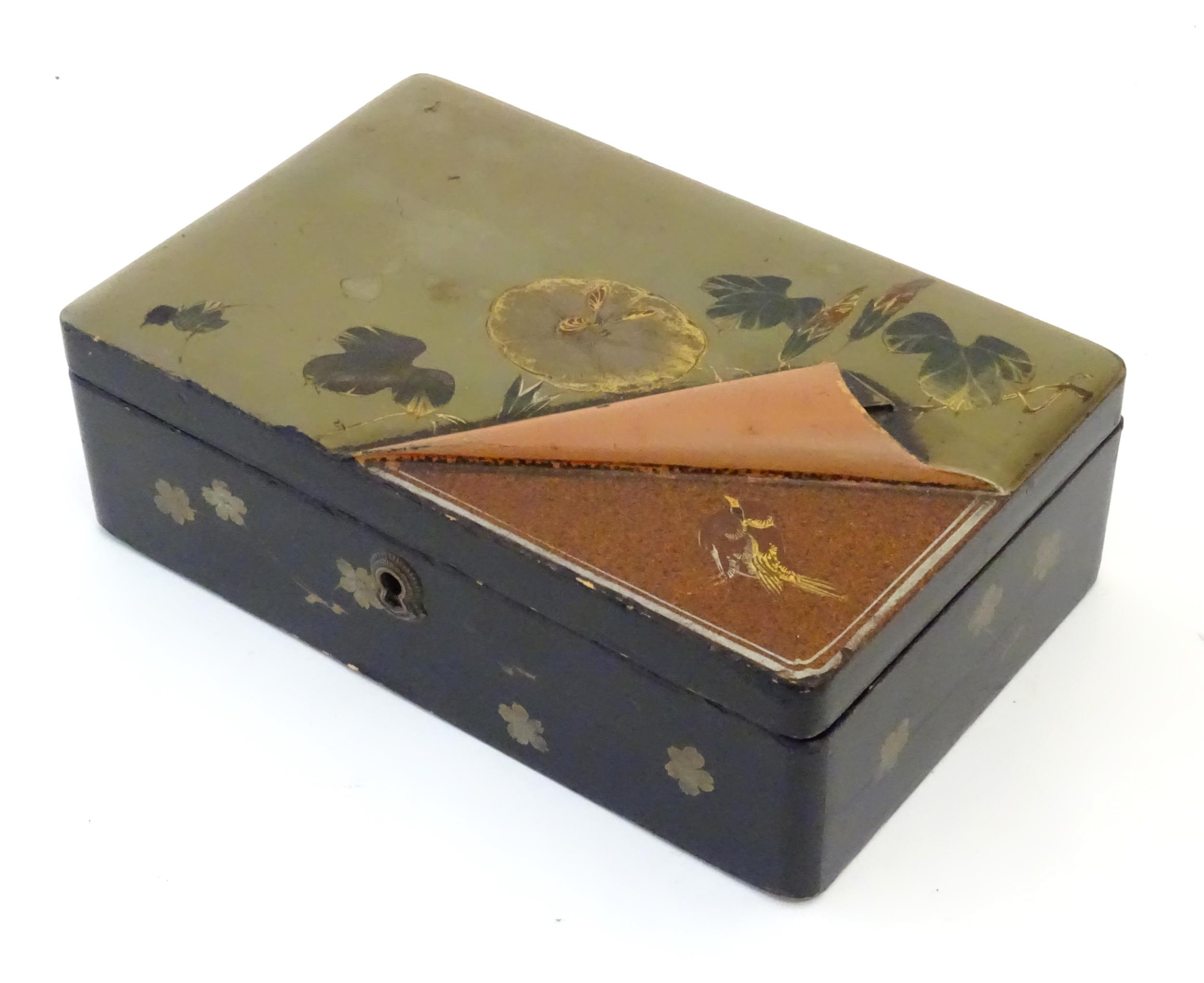 A Japanese lacquered box with hinge lid decorated with flowers and foliage, with faux lifted - Image 3 of 5