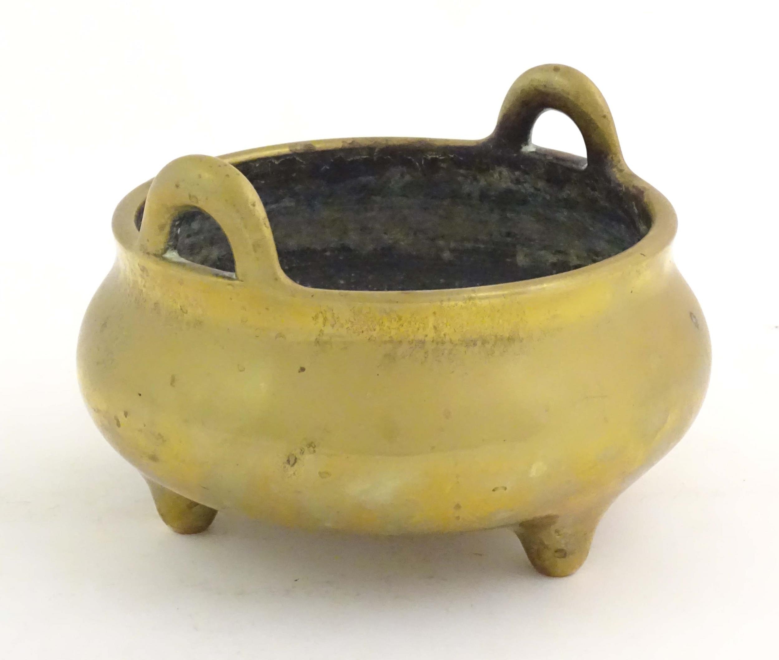 An Oriental three footed censer with twin handles. Character marked under. Approx. 5" high Please - Image 3 of 8