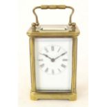 A brass carriage clock with white enamel dial. the whole 5 1/2" high Please Note - we do not make