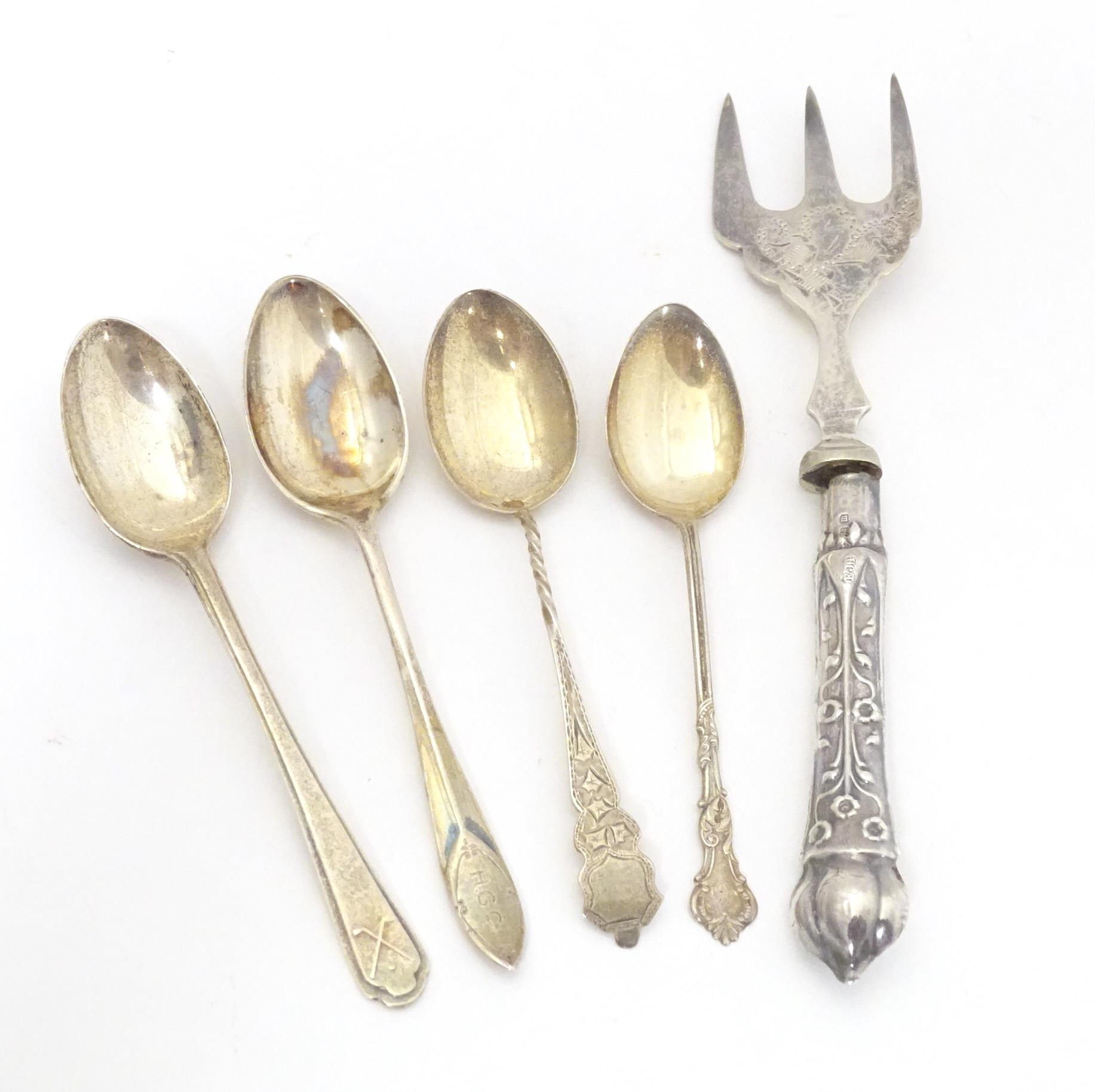 Four assorted silver teaspoons, together with a silver handled fork. Largest approx. 6 1/2" long (5)