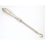 A sterling silver handled button hook with strapwork detail to handle. Approx. 6 1/2" long Please