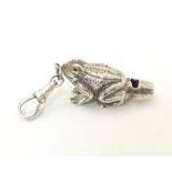 A white metal novelty whistle modelled as a frog. Approx. 1 1/2" long Please Note - we do not make