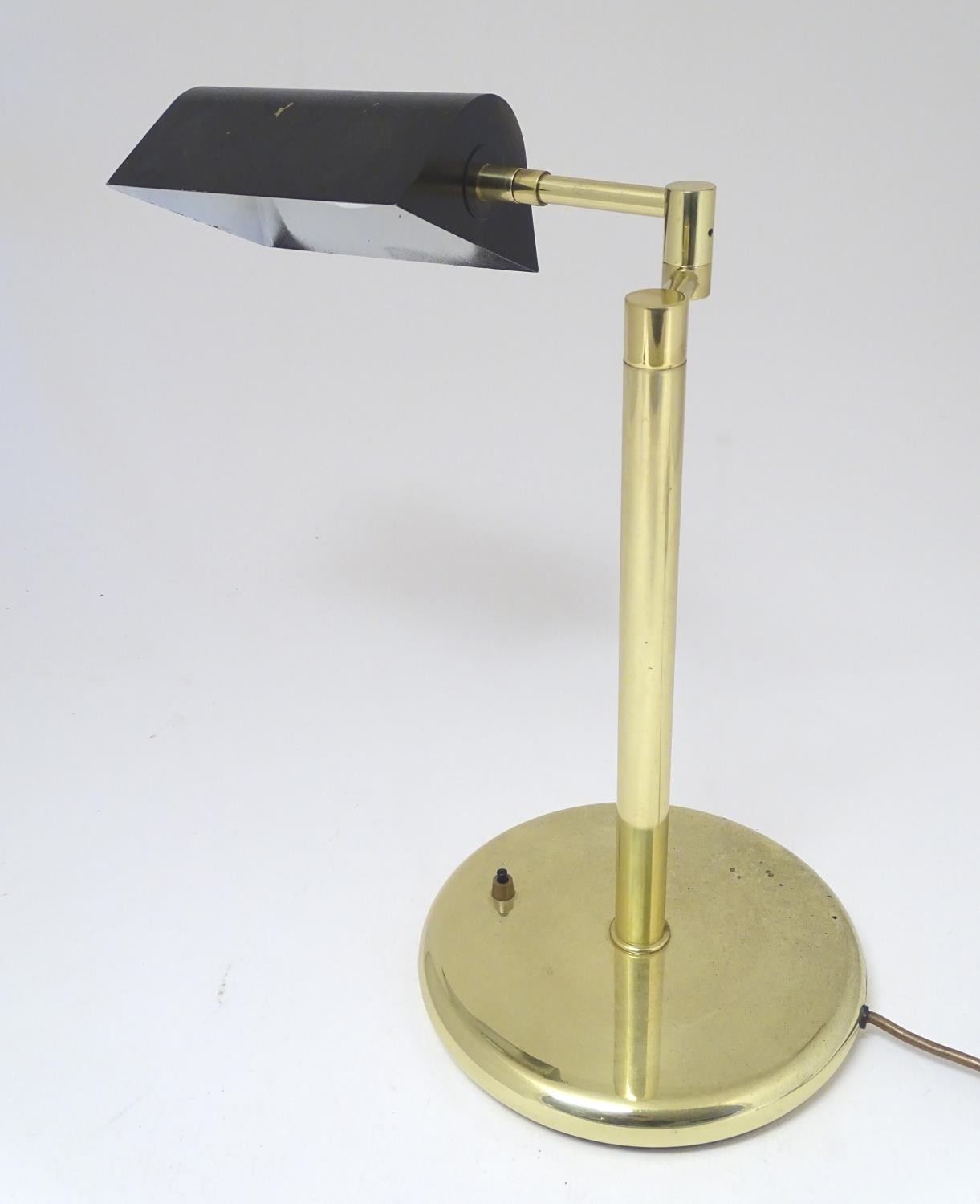 A mid to late 20thC Art Deco style brass table lamp, with articulated and adjustable shade and