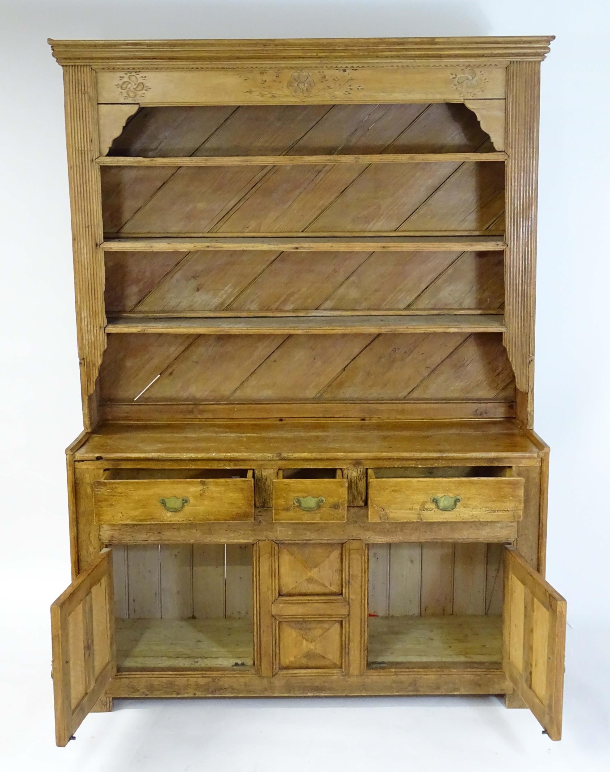 A 20thC pine dresser with a moulded cornice above floral carving flanked by reeded pilaster - Image 4 of 10