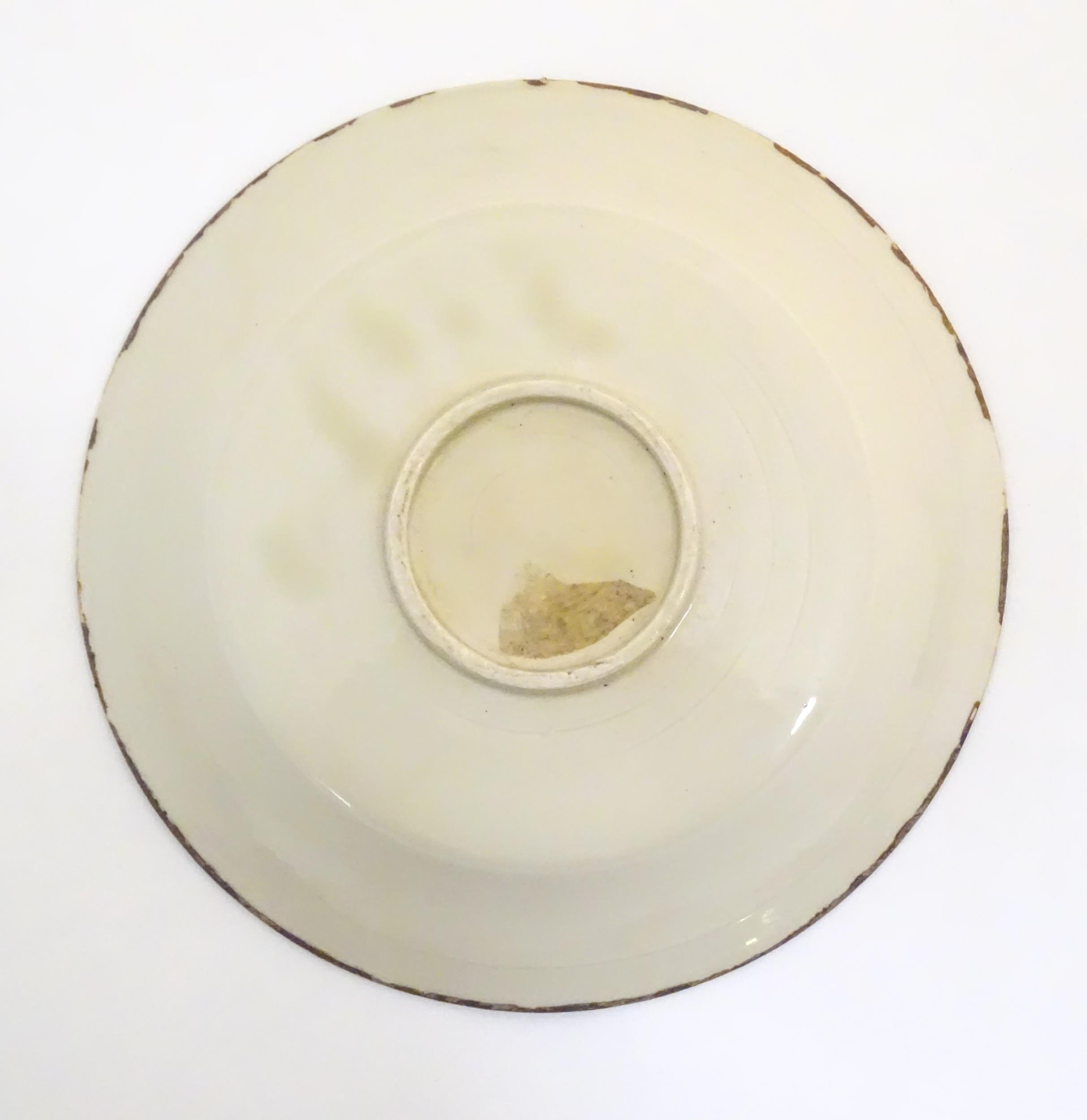 A Chinese Ding style dished plate with relief decoration depicting a stylised baby. Approx. 8" - Image 5 of 6