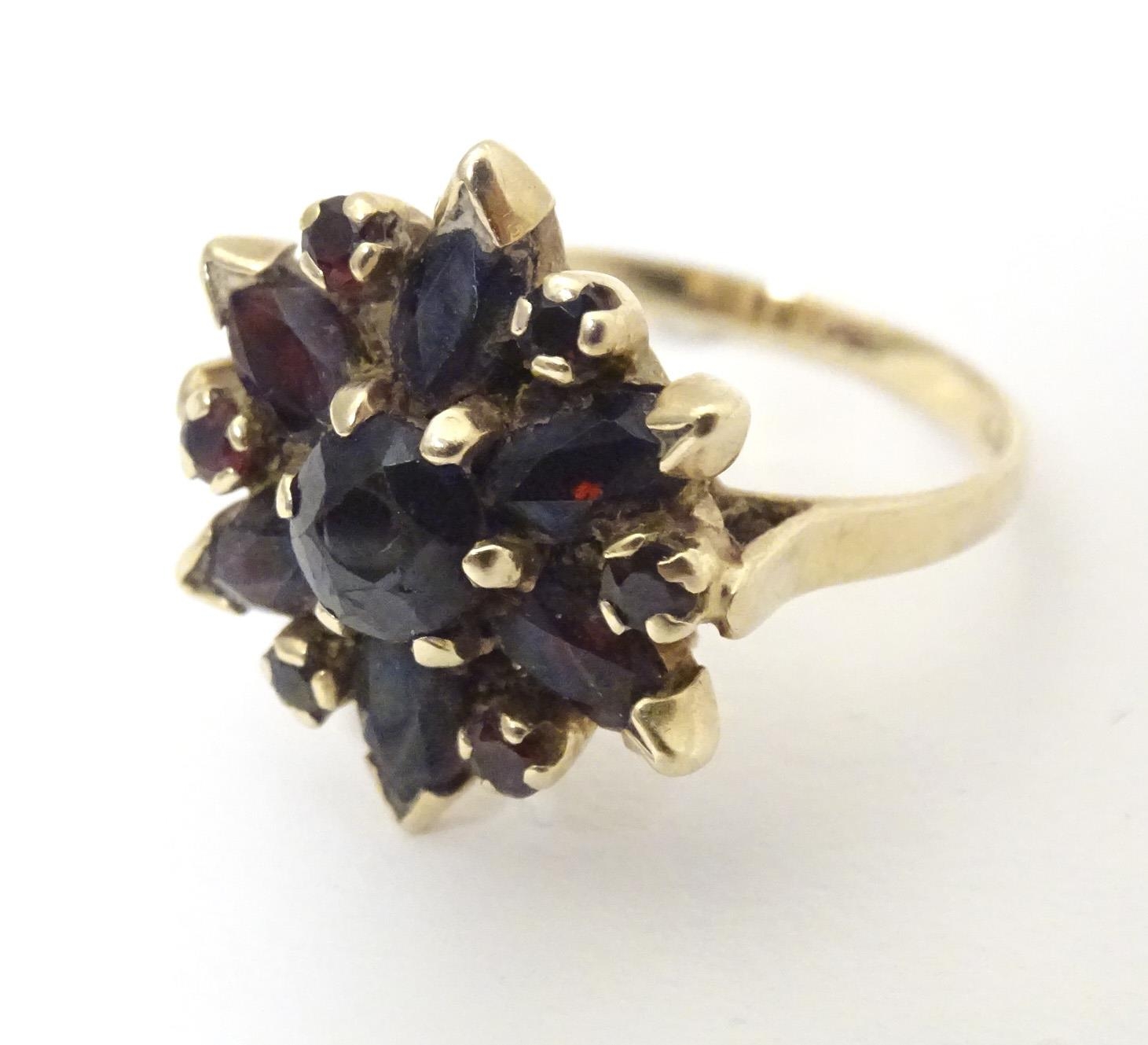 A 9ct gold ring set with garnets. Ring size approx R Please Note - we do not make reference to the - Image 3 of 7