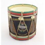 A mid 20thC novelty ice bucket formed as a military drum, bearing the regimental insignia of the