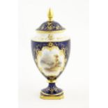 A Coalport vase and cover the central vignette decorated with hand painted landscape scene signed