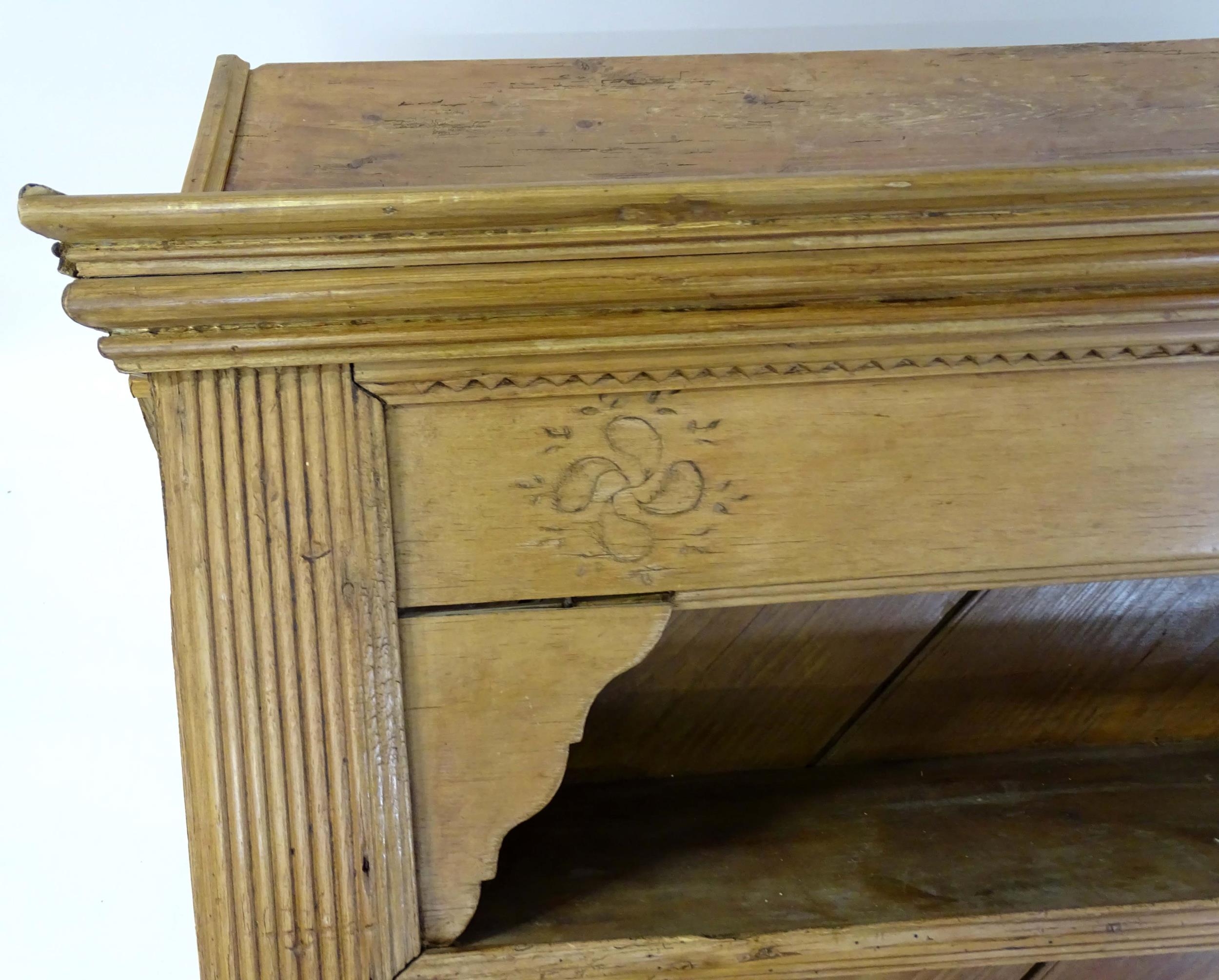 A 20thC pine dresser with a moulded cornice above floral carving flanked by reeded pilaster - Image 9 of 10