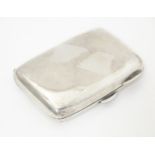 A silver cigarette case with gilded interior, hallmarked Birmingham 1904, maker Smith & Bartlam.