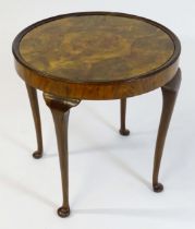 An early / mid 20thC walnut occasional / games table with a reversible top above four cabriole