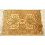Carpet / Rug : A beige ground carpet decorated with scrolling foliate detail. Approx. 61" x 97"