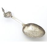 A silver caddy spoon with Dutch landscape scene to bowl, with import marks for London 1901, importer