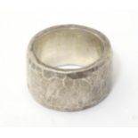 A silver dress ring with hammered detail, hallmarked 1985, maker Michael Allen Bolton. Ring size