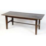 An 18thC oak refectory table with a three plank top above a peg jointed base raised on four tapering