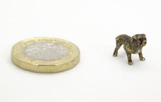 A cold painted bronze model of a dog. Approx. 3/4" long Please Note - we do not make reference to