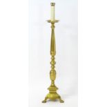 A mid to late 20thC brass standard lamp, the sectional column terminating in a cup with faux