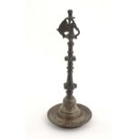 An Indian / Deccan cast temple style oil lamp with turned column surmounted by a Hamsa bird. Approx.