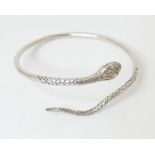 A silver bangle formed bracelet modelled as a snake, hallmarked London 1991 Please Note - we do