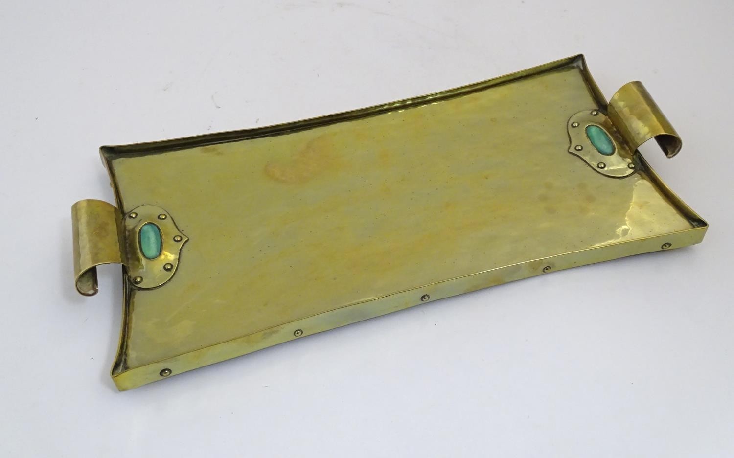 An Arts & Crafts brass tray with twin scroll handles and Ruskin style cabochon and rivet detail. - Image 8 of 9