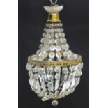 A 20thC crystal drop bag pendant ceiling light, the circular brass frames supporting two tiers of