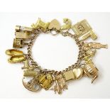 A 9ct gold charm bracelet set with 18 various 9ct gold charms to include charms modelled as a