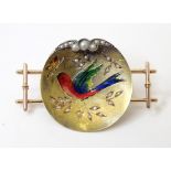 A gold and gilt metal brooch / pin with enamel bird decoration and seed pearl detail. 1 3/4" wide