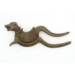 A 19thC cast bronze betel nut cracker / cutter modelled as a stylised dog. Approx. 8" long Please