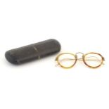 A cased pair of c1940s bifocal spectacles / glasses, with faux tortoiseshell and gilt metal
