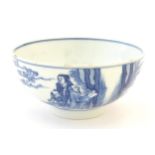 A Chinese blue and white bowl decorated with figures in a garden landscape with lanterns.