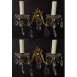 A pair of 20thC gilt twin branch wall lights, the gilt mounts supporting cut glass cups with
