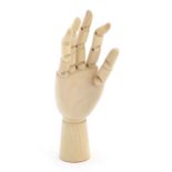 An artist's wooden articulated lay hand. Approx. 7" high Please Note - we do not make reference to