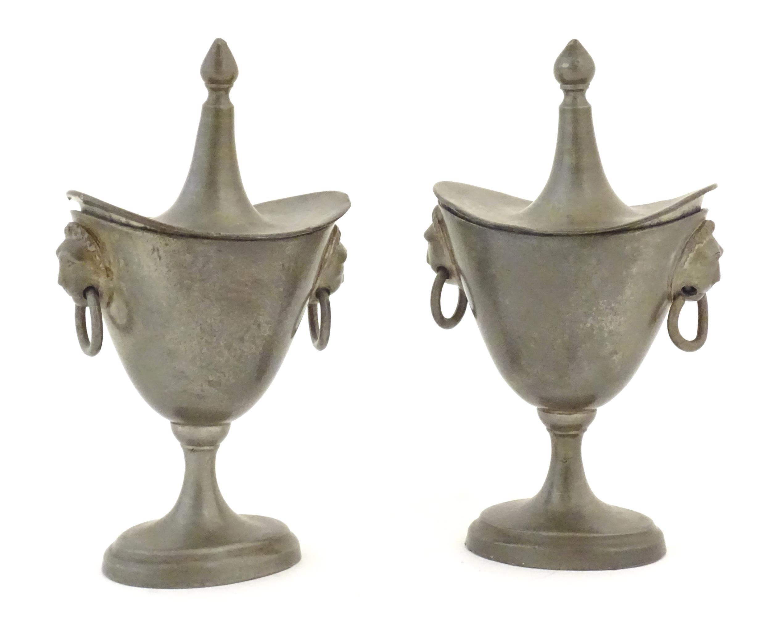 Two 19thC pewter salts modelled as lidded urns with twin lion mask ring handles. Approx. 5" high (2)