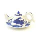 A small Chinese blue and white teapot of octagonal form decorated with koi / carp fish. Character