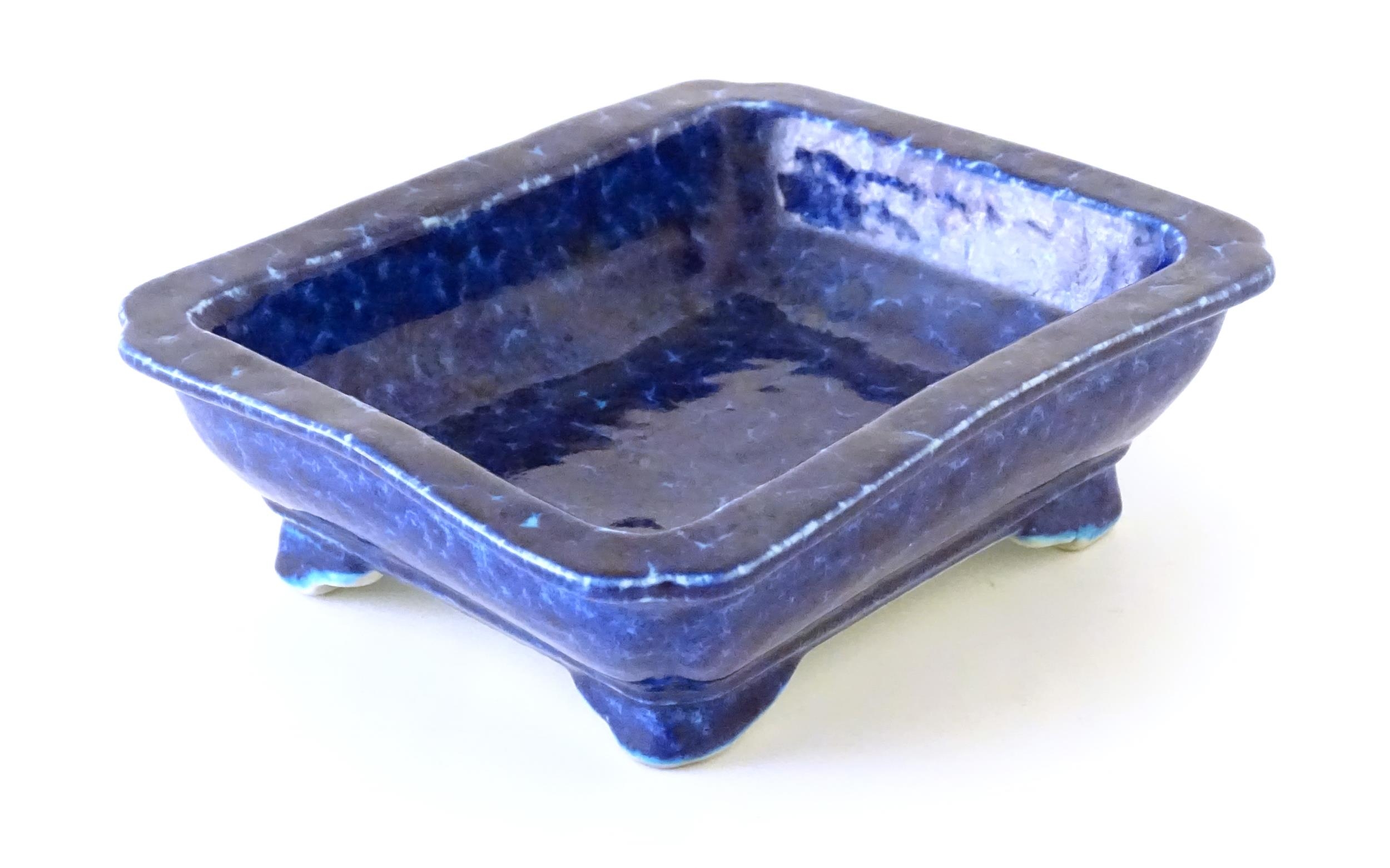 A Chinese dish of rectangular form with a blue glaze, raised on four feet. Character marks under. - Image 5 of 8