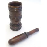 Treen: A 19thC turned pestle and mortar with banded decoration. Mortar approx. 8" high. Please