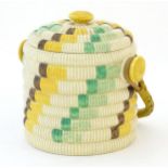 A Clarice Cliff biscuit jar / barrel with swing handle in the Raffia pattern. Marked Bizarre by