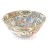 A Cantonese famille rose bowl with panelled decoration depicting figures in traditional dress in