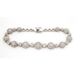 A silver bracelet set with diamonds. Approx 7 1/2" long Please Note - we do not make reference to