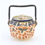 An octagonal biscuit barrel decorated in the Imari palette. Marked under Octagon 24 England. Approx.