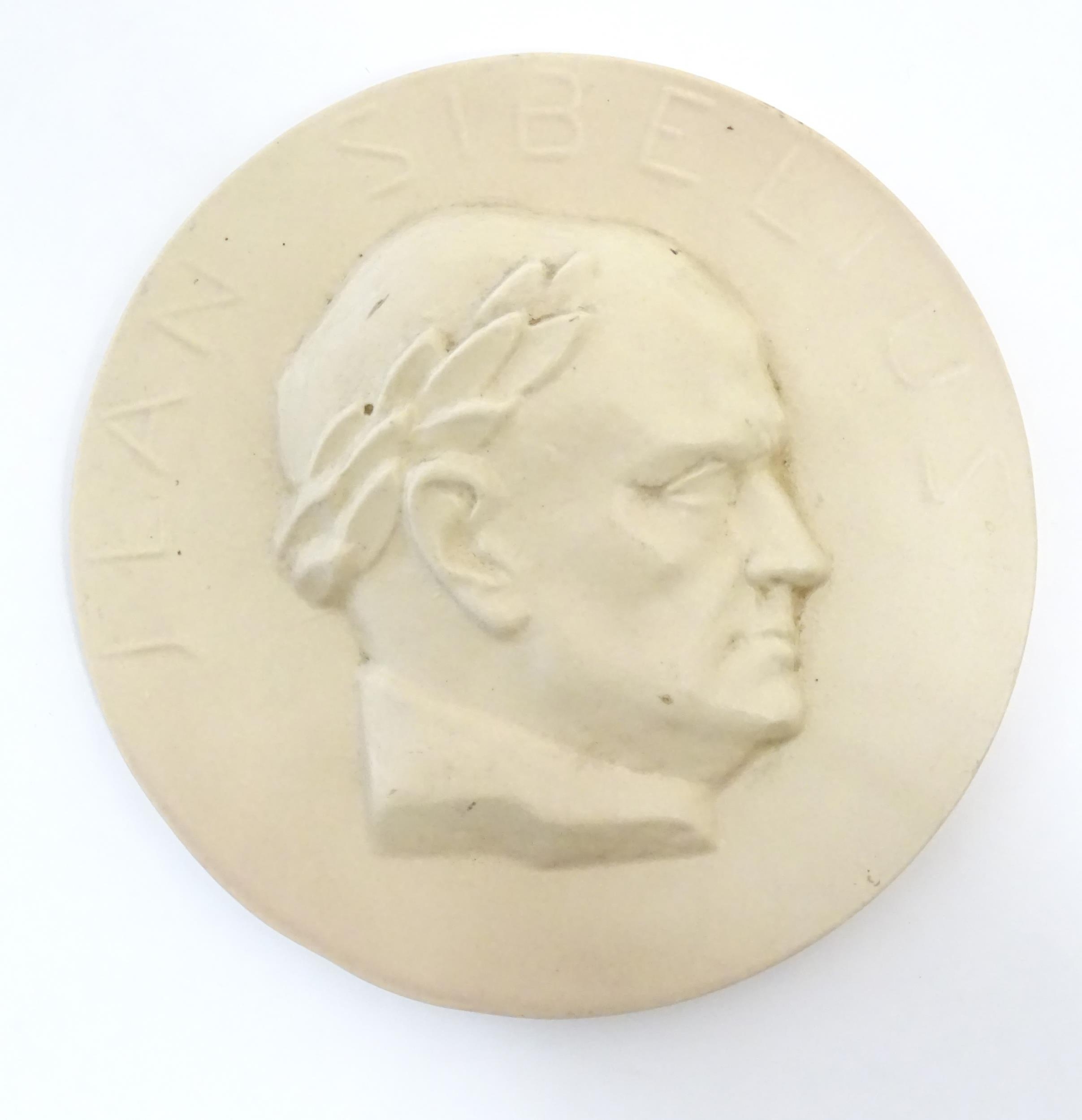 A 20thC Arabia ceramic roundel / plaque depicting a portrait of the Finnish composer Jean Sibelius