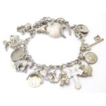 A silver / white metal charm bracelet set with various charms Please Note - we do not make reference