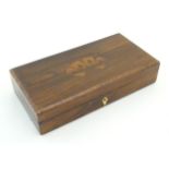 A 19thC rosewood games box, the lid decorated with playing card suits opening two reveal a fitted