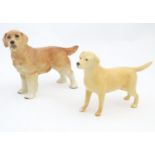 A Beswick model of a Yellow Labrador, no. 2287. Together with a model of a Golden Retriever. Marked