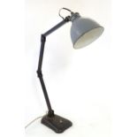 A mid 20thC vintage industrial table / desk lamp, of steel construction with adjustable arm and grey